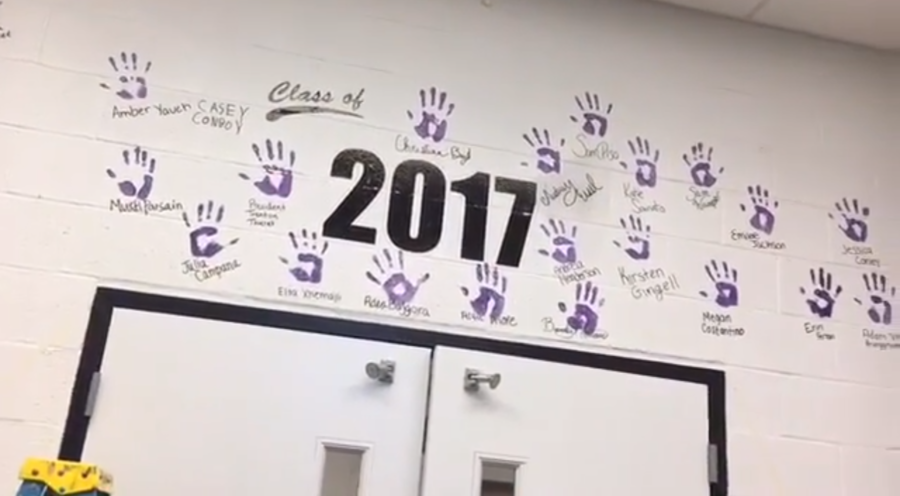 2017 seniors place their hand prints on their wall. 