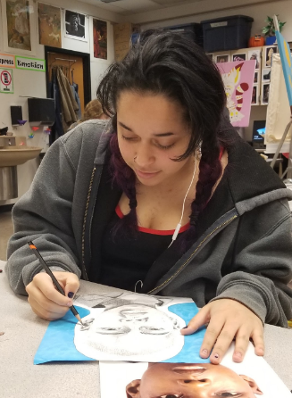 Junior Jayla Wicks drawing her portrait.