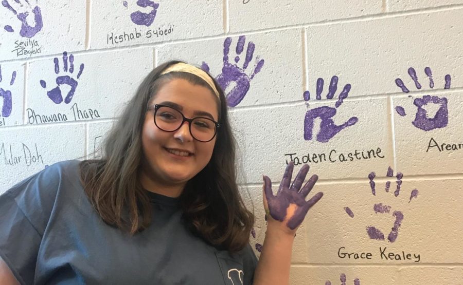 Senior Jaden Castine shows off her purple handprint.