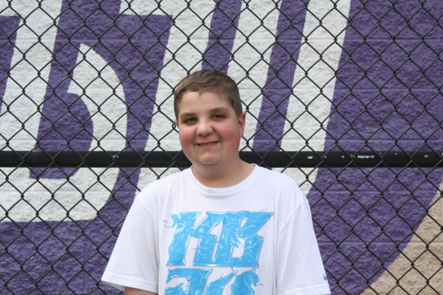 The manager: Junior Dom Giorgianni stands by the batting cage before a softball game. Giorgianni manages three sports teams for Baldwin.