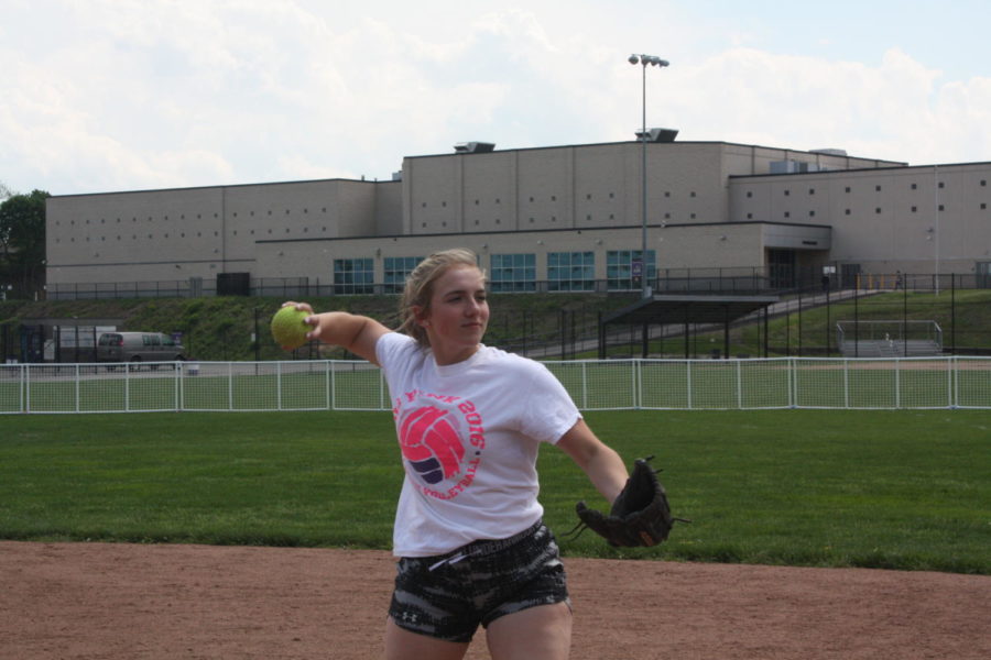 Making the play: Junior Cassie Carlson throws to first base in practice. The team has finished in first place for four consecutive years in its section.