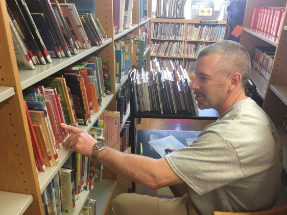 Helping out: Teacher Dale Kreuer help out at the Whitehall Public Library. Staff and students completed service projects throughout Baldwin, Whitehall and the region during the districts first Day of Caring.