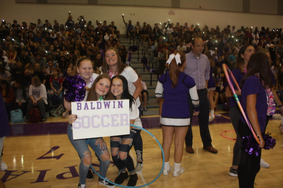 Members of the girls soccer team show off their sign. 