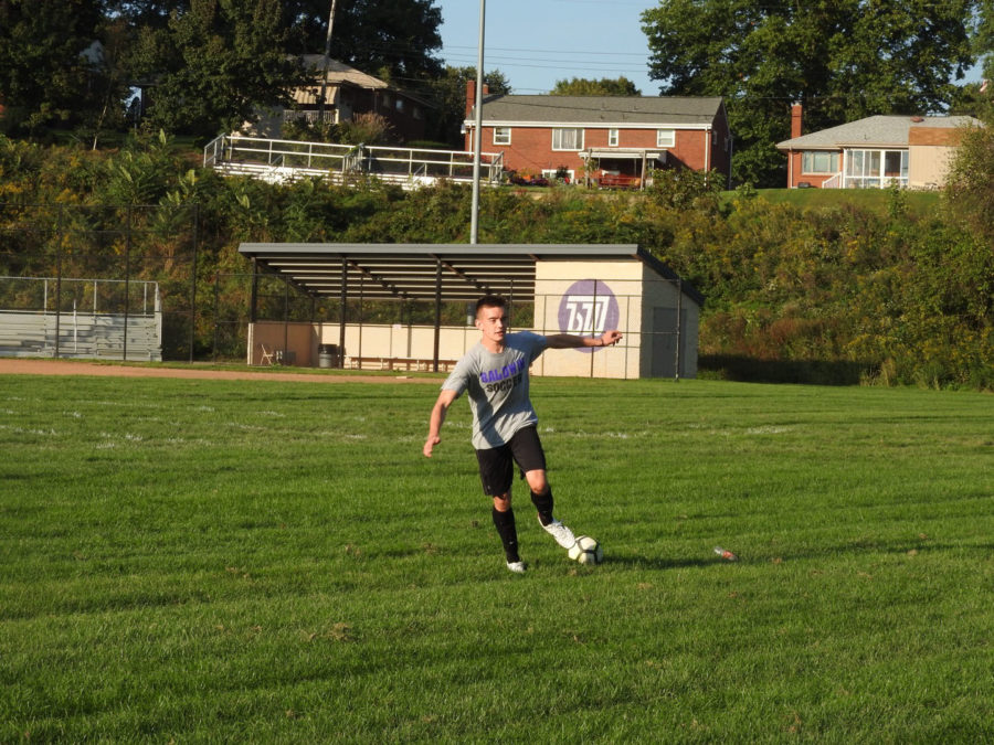 On the go: Senior Austin Sabo dribbles a ball during practice. Sabo and senior Mitchell Kress returned to the team this year.