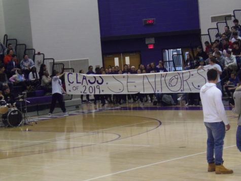 Senior team enters gym for pep rally. The seniors are coached by teachers and students. 