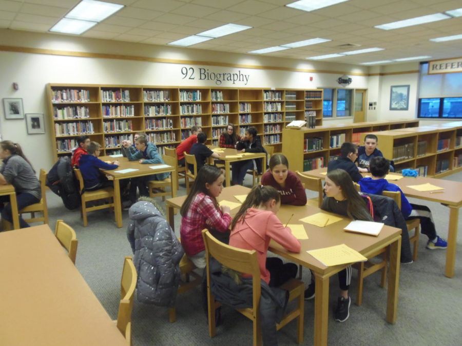 Middle school students compete in the library.
