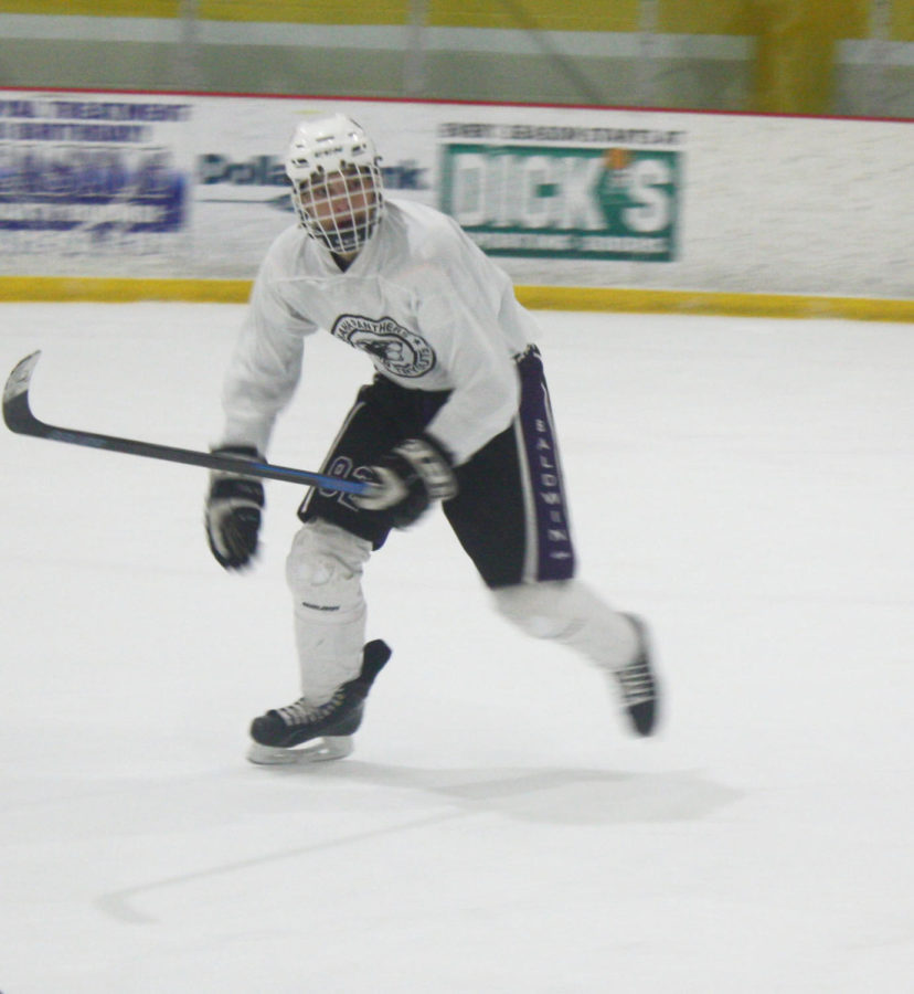 Leader of the rink: Senior Nathan Hobson skates for a puck in practice. Hobson plays for both the inline and ice hockey teams and is the captain for both.