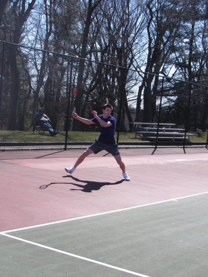 Serving as a leader: Junior Remy Davic faces an opponent at a match during the beginning of the season. Davic has been playing tennis since the third grade and has shown success over the years.