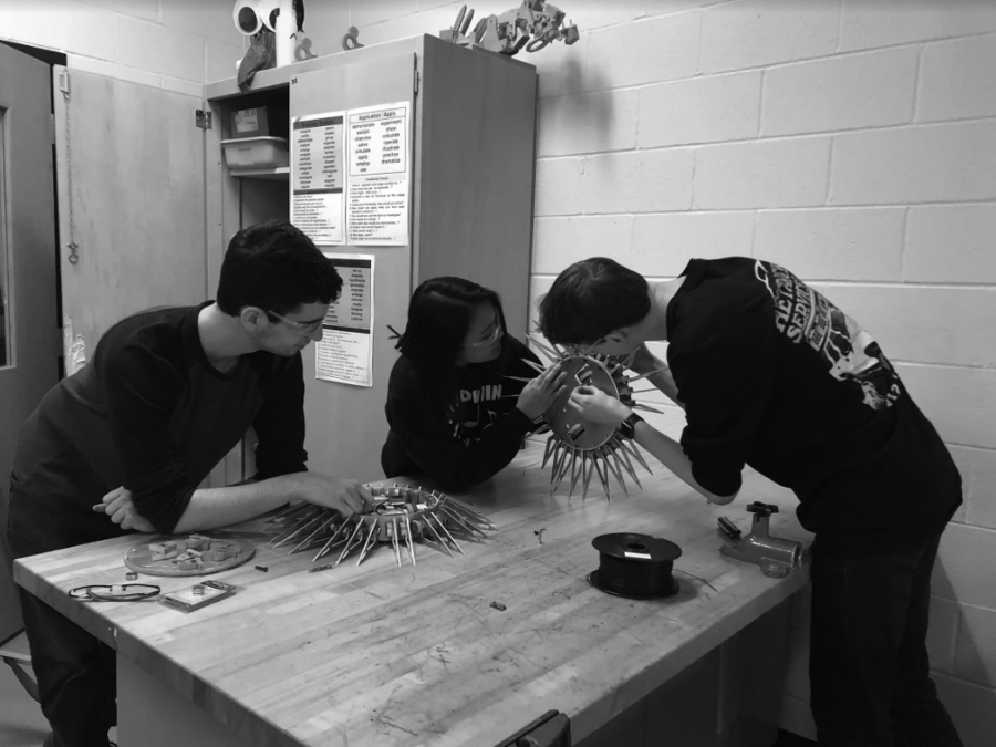 Building the bot:  Seniors Joshua Luxemburger (left), Yee 
Khine (middle), and Billy Andrews work on building a robot for their upcoming competition. This year, the club is working on a new design for their robot.