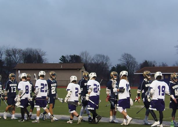 The two teams congratulate each other on a good game. Boys lacrosse took a tough loss Friday.