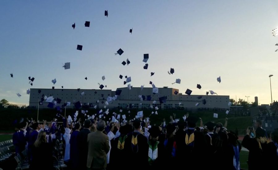The graduates of the Class of 2019 throw their caps in the air after receiving their high school diplomas. 
