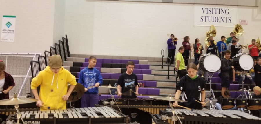 Students practice with the band before the pep rally begins.