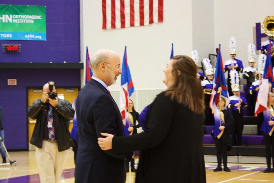 Wolf greets Marissa Virgin, Band Director, in the gym.