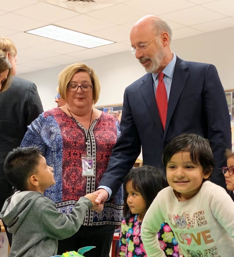 Wolf shakes hands with a Head Start student