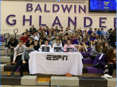 Three Baldwin students created a mock ESPN table and set it up in front of the student section at Fridays boys basketball game.