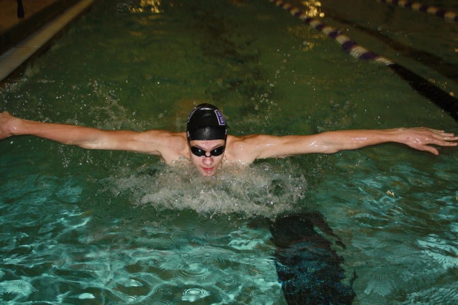 Junior Dylan Stokes works on his butterfly stroke at swim practice. Stokes began to grow as a leader this season and was named co-captain.