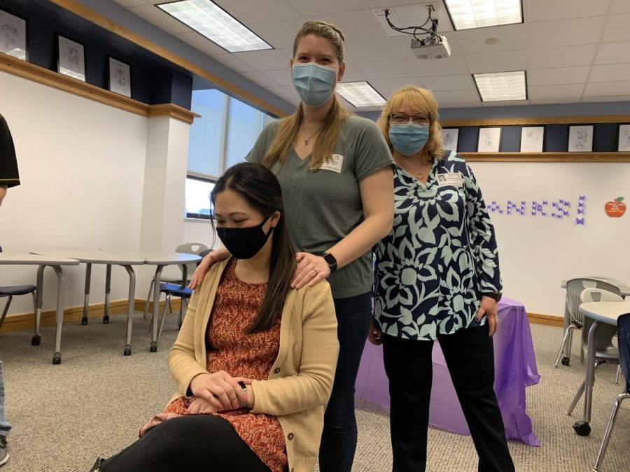 Science teacher Jia Fetterolf gets a chair massage as part of the first program organized by the Joy Project at the high school.