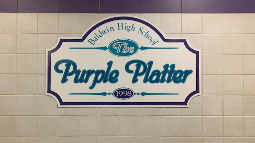 The "Purple Platter" sign appears in the South Cafe of the high school.