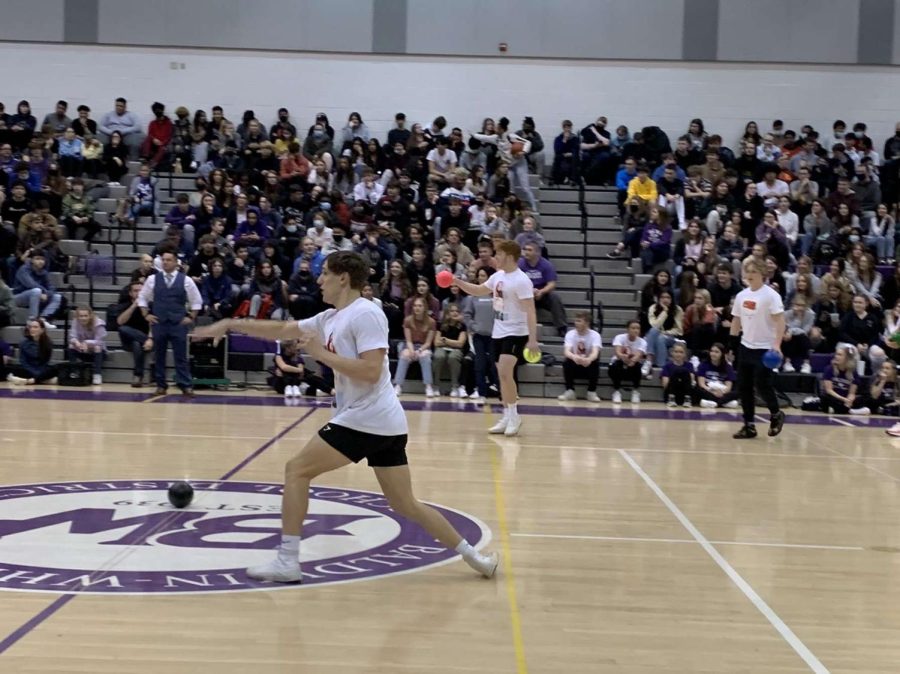 Senior Cody Randal throws a dodgeball during the games at the pep rally. 
