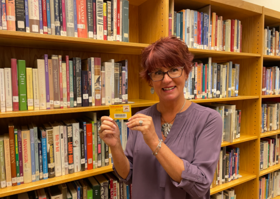Brigetta Del Re holds a public library card in the BHS library.