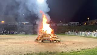 The bonfire at the end of the night is the highlight of the annual homecoming carnival.