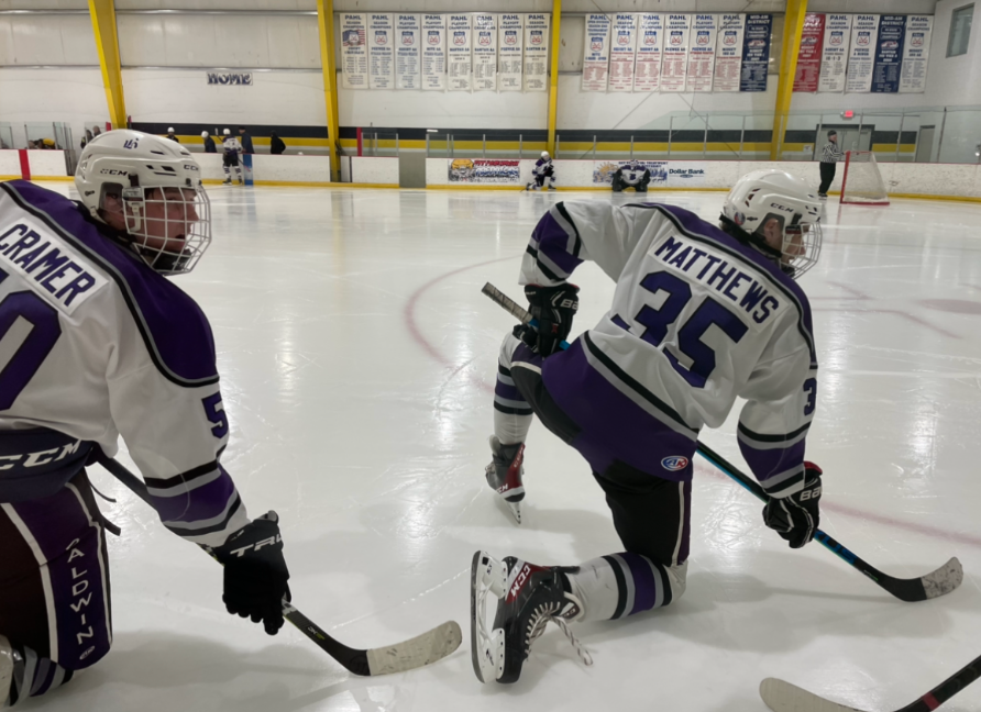 Seniors Ben Cramer and Tanner Matthews warm up for the third period of play.