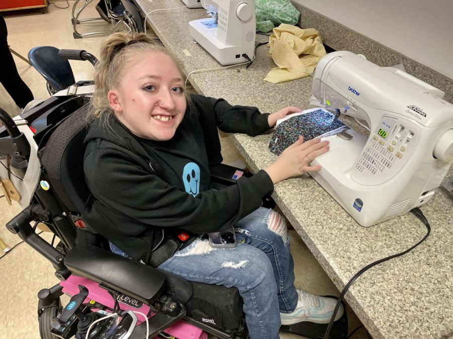 Junior Brianna Rodgers shows off the adapted push-button sewing machine. 
