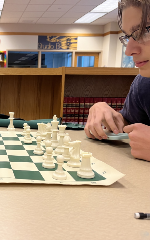 The Baldwin chess club President, Joey Priano, studies his next move. 