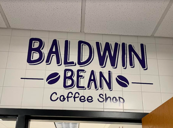The vinyl sign above the coffee shop the Baldwin Bean welcomes students into the room. 