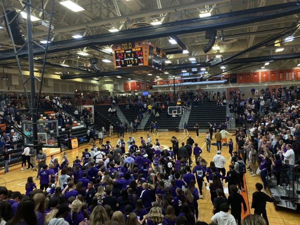 The purple flood storms the court as the Highlanders win 54-52.
