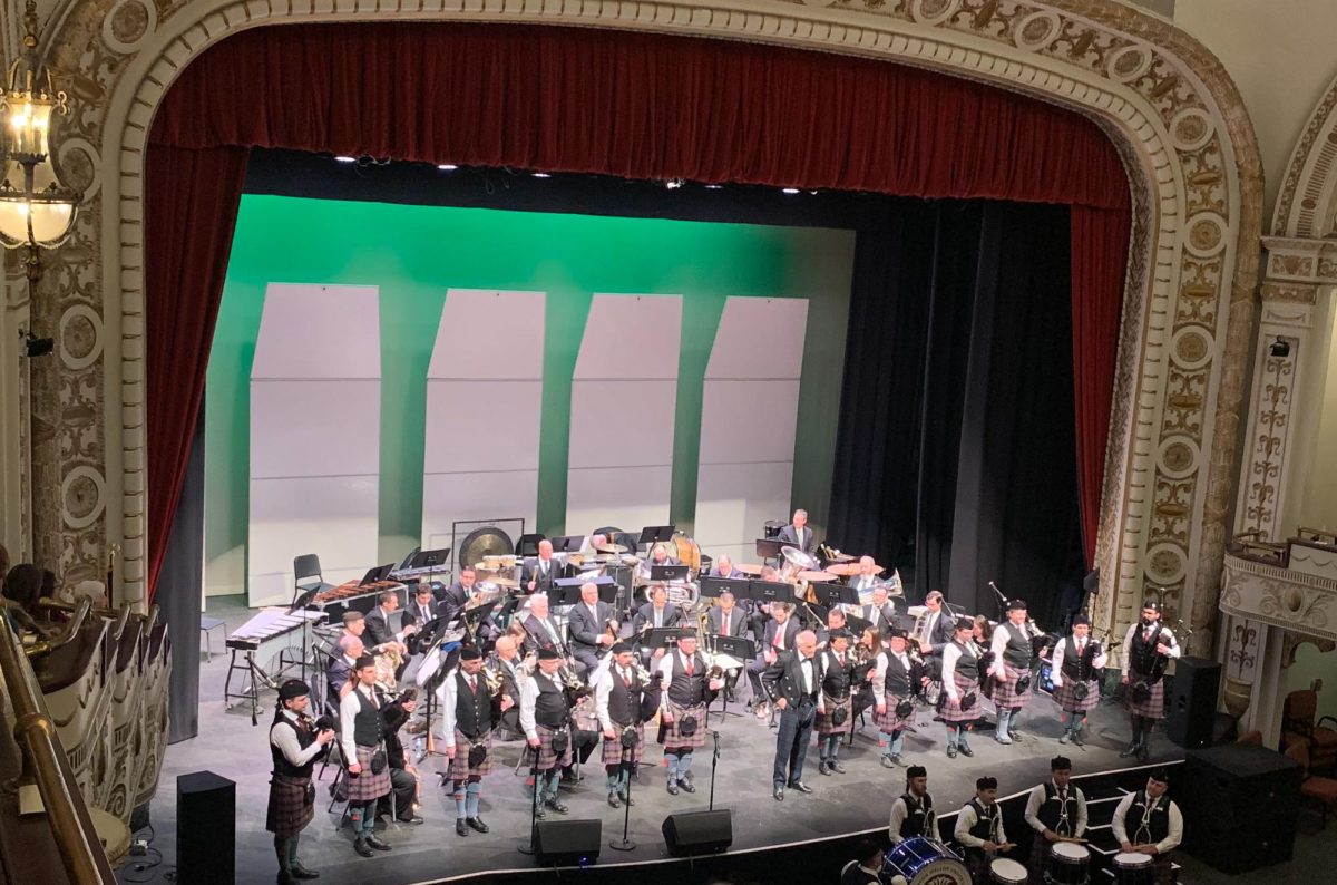 The River City Brass Band on stage accompanied by the Carnegie Mellon University Pipes and Drums Band.