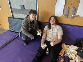 Red Cross club member Alex Kearney (left) offers snacks to blood donor Hayden Baroni at the spring blood drive. 
