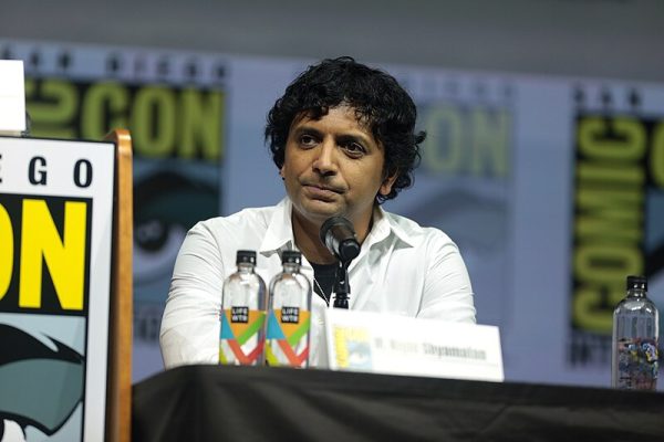 M. Night Shyamalan at the 2018 San Diego Comic Con panel for his film  Glass. Shyamalan by Gage Skidmore is licensed under CC BY-SA 2.0 DEED