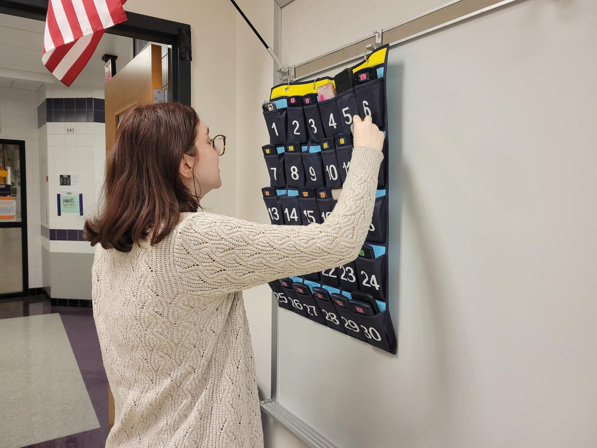 Sophomore Chloe Barnhart replaces her phone with a calculator before math class. Some districts have gone further than Baldwin, banning phone use by students throughout the entire school day.