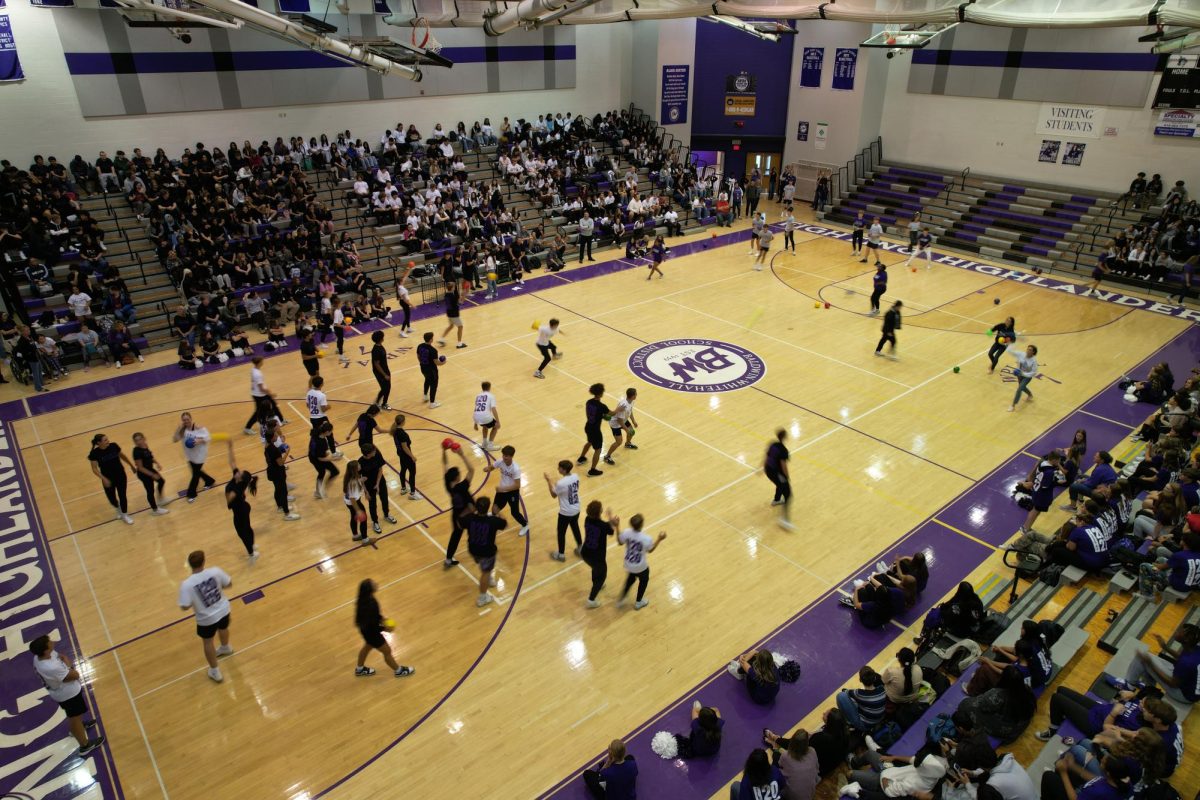 Students play dodgeball during the homecoming pep rally in the gym.