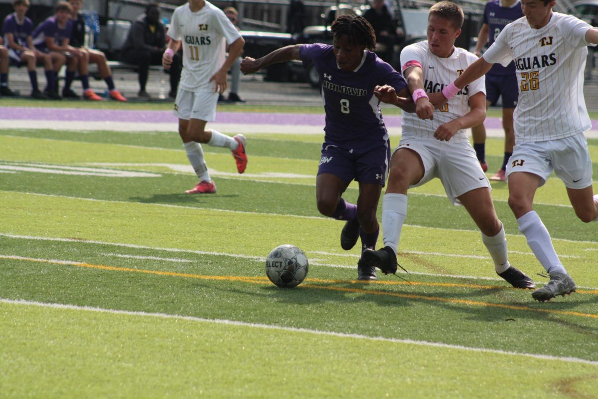 Senior Chris Sandy runs with the ball in TJ's territory.