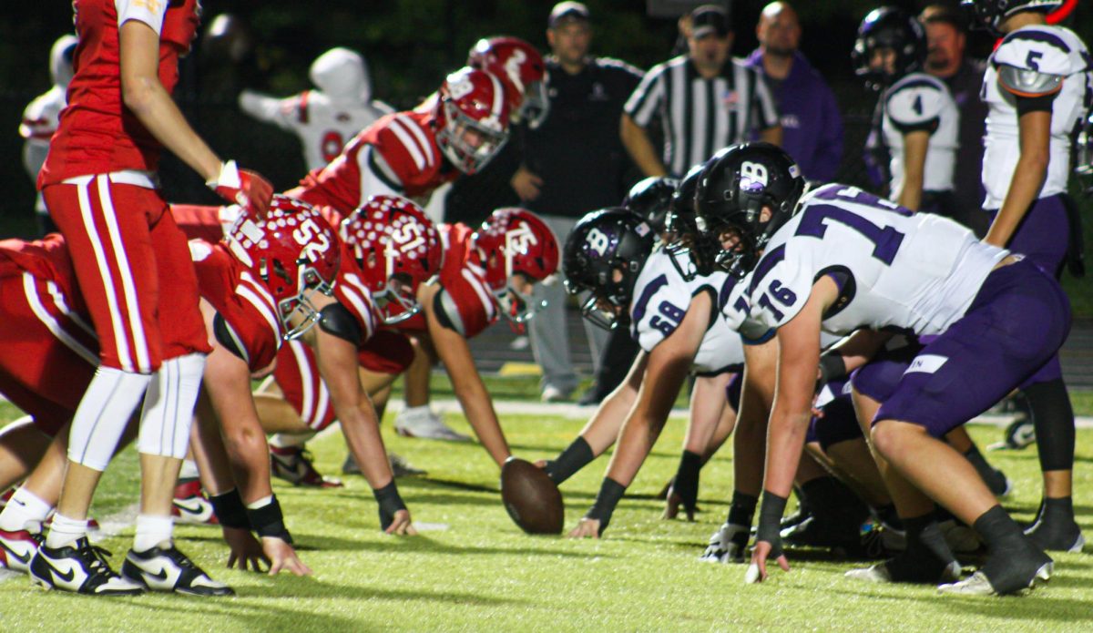 Baldwin prepares to hike an offensive snap against Moon at the homecoming game.