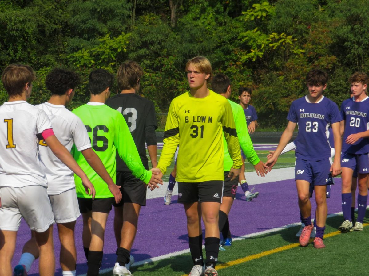 Senior Gabe Herrle shakes hands with TJ players after the game.