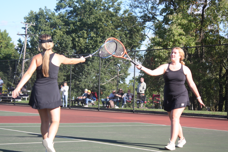 Junior Chelsea Luxemburger and senior Julia Johnson celebrate after scoring a point. 