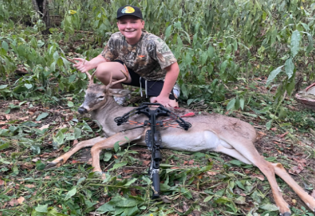 Donald Brown poses with the buck he shot during his freshman hunting season, when he was 15. Photo credit by Donald Brown. 