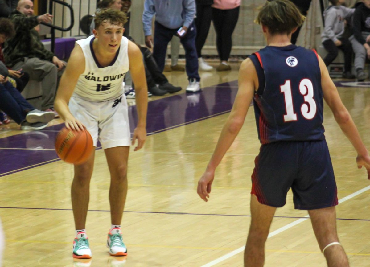 Junior Max Marzina dribbles the ball down the court against Shaler.