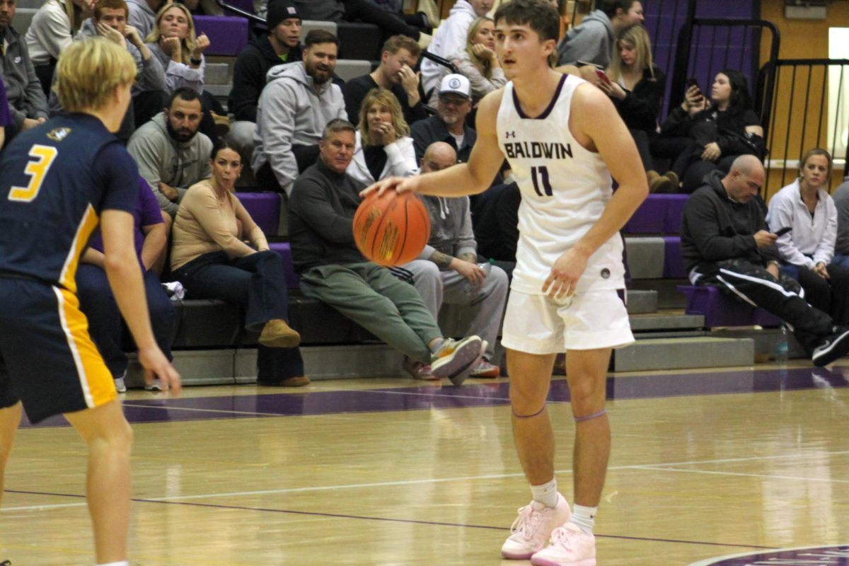 Senior Nate Wesling dribbles down the court against Mount Lebanon. 