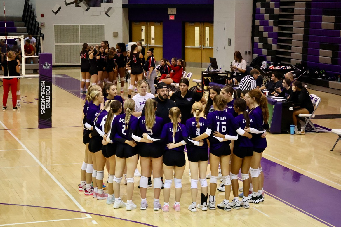 The girls volleyball team meets in their huddle to discuss the game plan. Photo courtesy of Jason Jonas. 