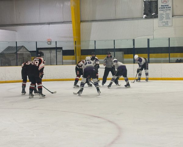 Senior Logan Cramer lines up at center for the faceoff in the offensive zone.