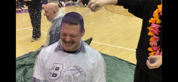 The principals got their hair dyed purple during the winter sports pep rally.