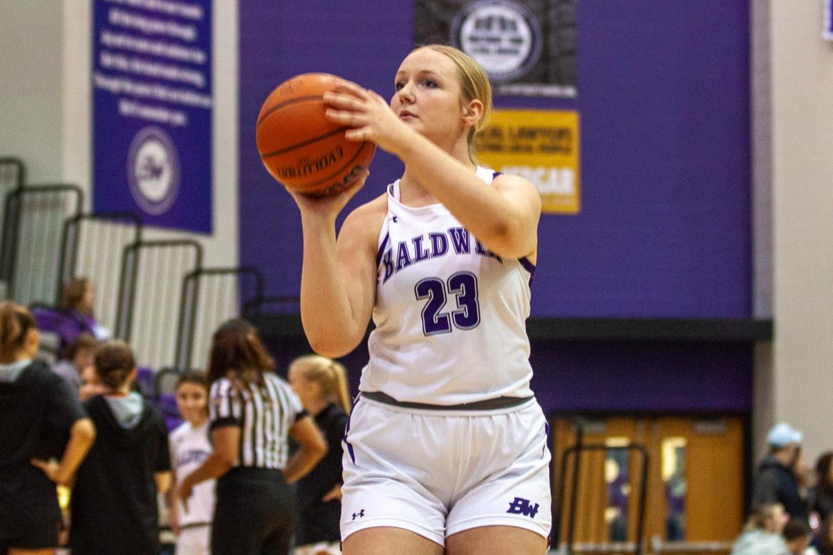 Senior Rebecca Knight practices shooting free throws in warmups before the game.