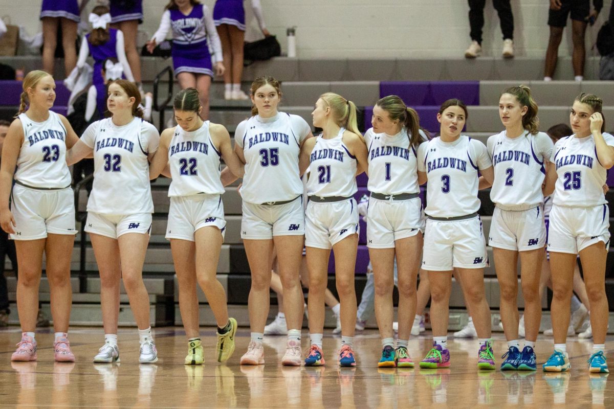 The team stands during the playing of the national anthem against Elizabeth Forward. 