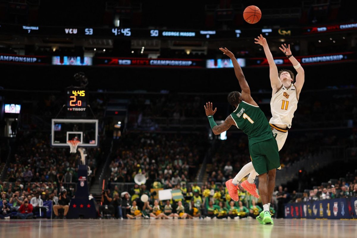 Mar 16, 2025; Washington, D.C., USA; VCU Rams guard Max Shulga (11) is fouled by George Mason Patriots guard Jared Billups (1) while shooting a three point field goal in the second half at Capital One Arena. VCU plays in one of the tournaments key games. Geoff Burke-Imagn Images