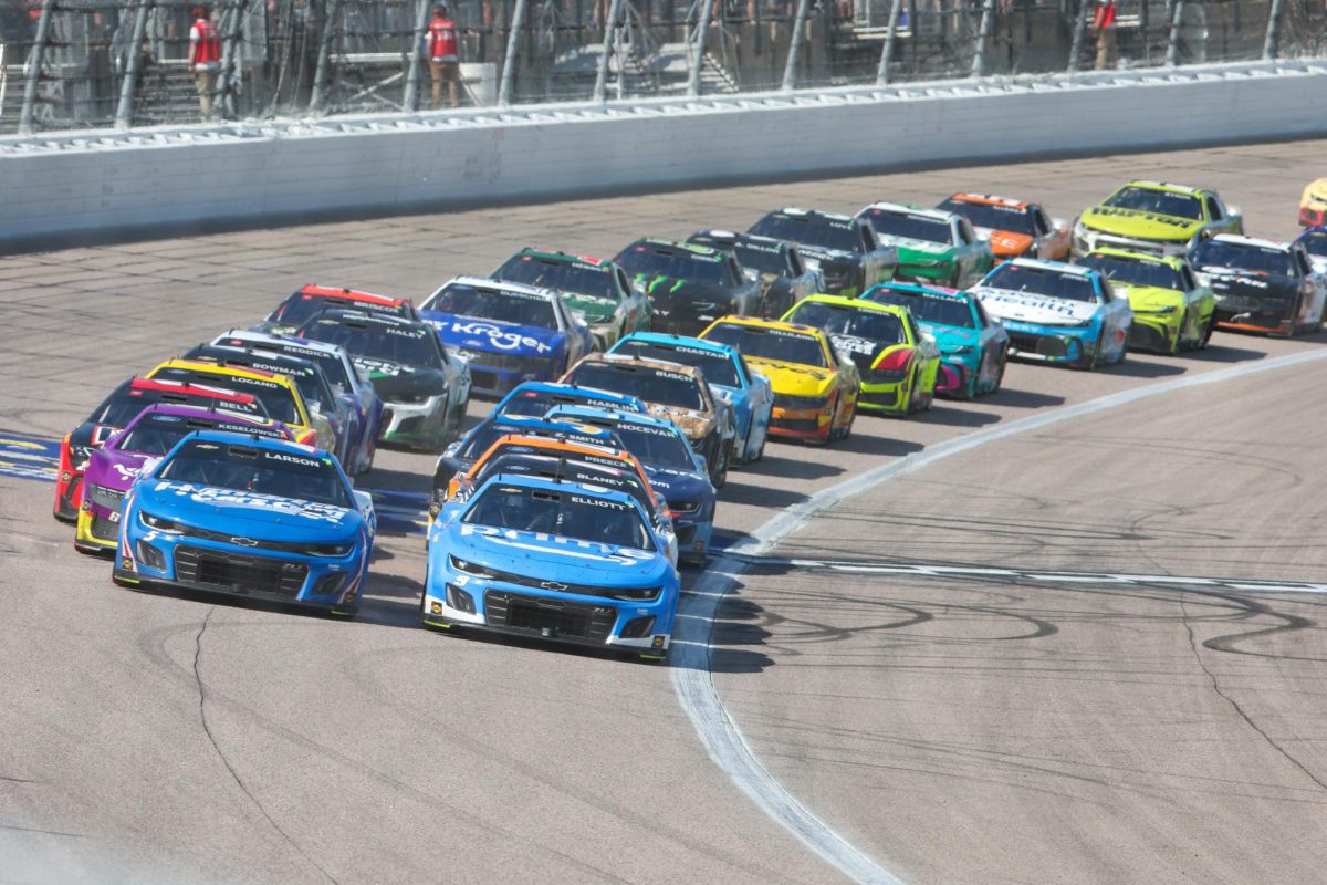 May 11, 2025; Kansas City, Kansas, USA; NASCAR Cup Series drivers Chase Elliott (9) and Kyle Larson (5) lead the pack during a restart at the AdventHealth 400 at Kansas Speedway. Mandatory Credit: Scott Sewell-Imagn Images