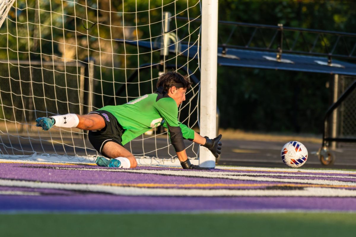 Junior Eli Schuchert makes a diving save during warmups against South Park.